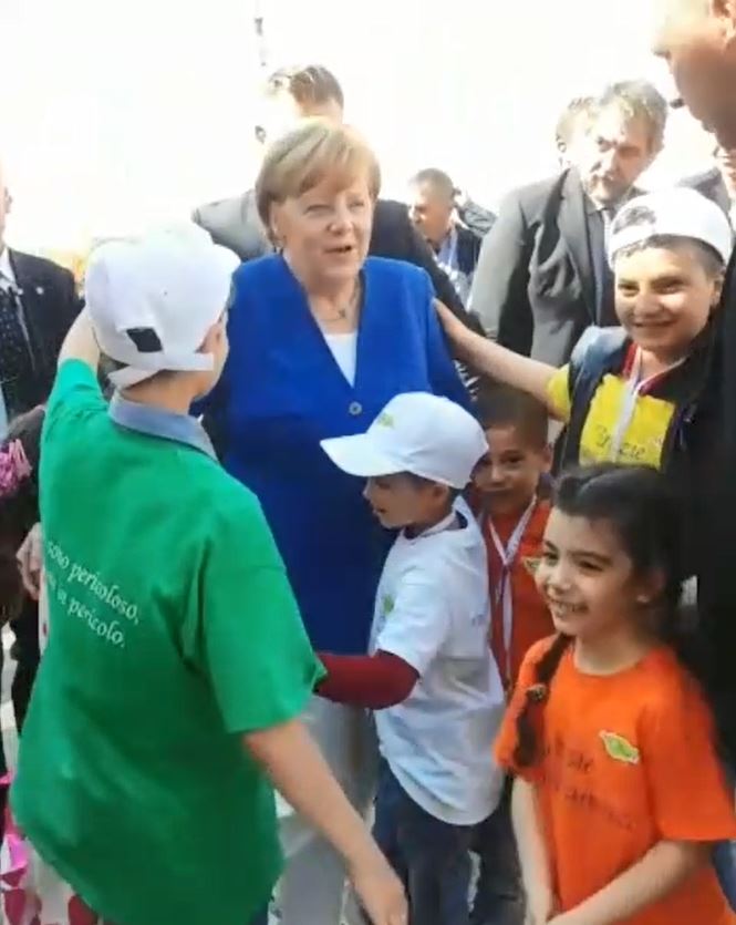 I piccoli di Auxilium corrono ad abbracciare Angela Merkel